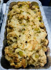 A tray of oyster stuffing sitting on a table.